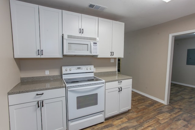 kitchen featuring white cabinetry, visible vents, dark wood-style floors, baseboards, and white appliances