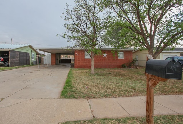 ranch-style home featuring driveway, a front lawn, a carport, and brick siding