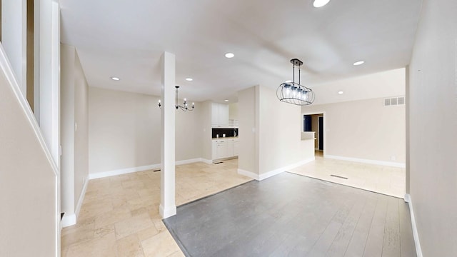 interior space with a notable chandelier and light wood-type flooring