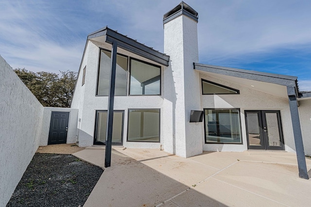 back of property featuring french doors and a patio