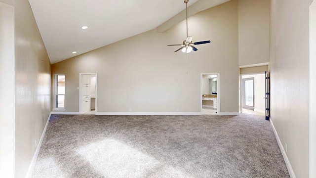 unfurnished living room featuring beam ceiling, high vaulted ceiling, light colored carpet, and ceiling fan