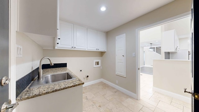 washroom featuring cabinets, hookup for an electric dryer, hookup for a washing machine, and sink