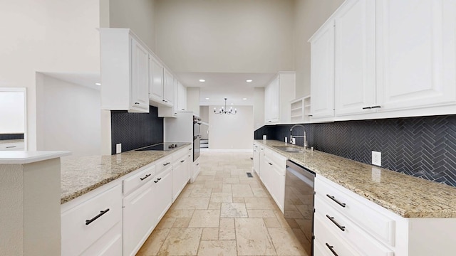 kitchen with white cabinets, light stone countertops, sink, and black appliances