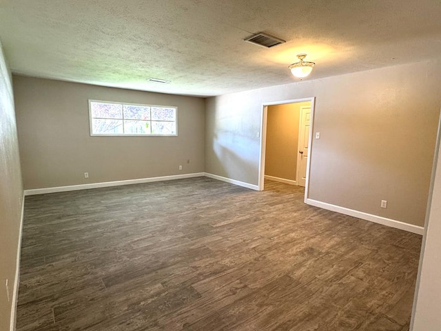 909 Douglas Ave, Midland, TX 79701 - spare room with a textured ceiling and dark wood-style flooring