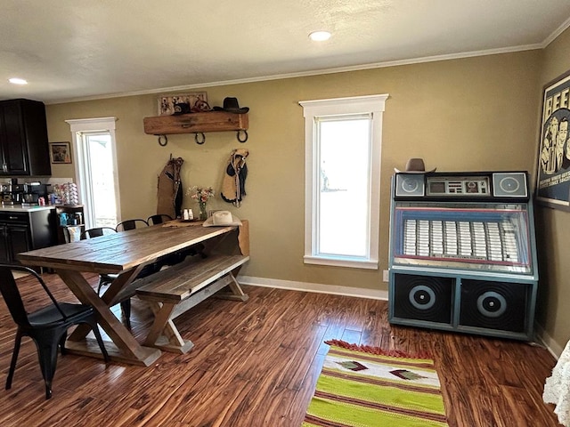 dining area with baseboards, wood finished floors, and ornamental molding