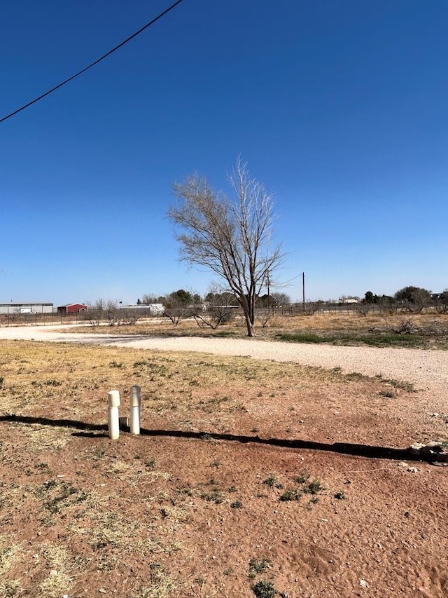 view of yard with a rural view