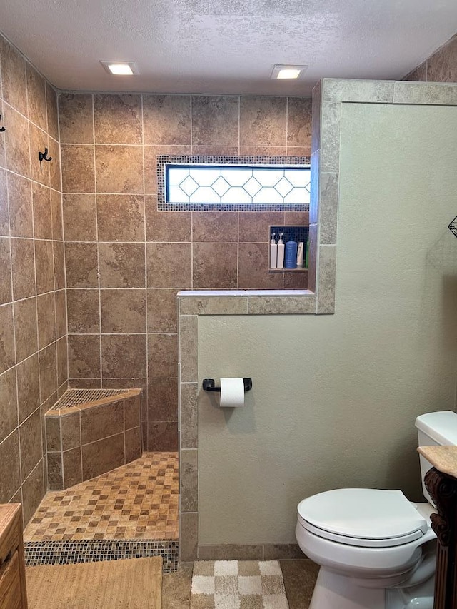 full bath with a textured ceiling, toilet, and walk in shower