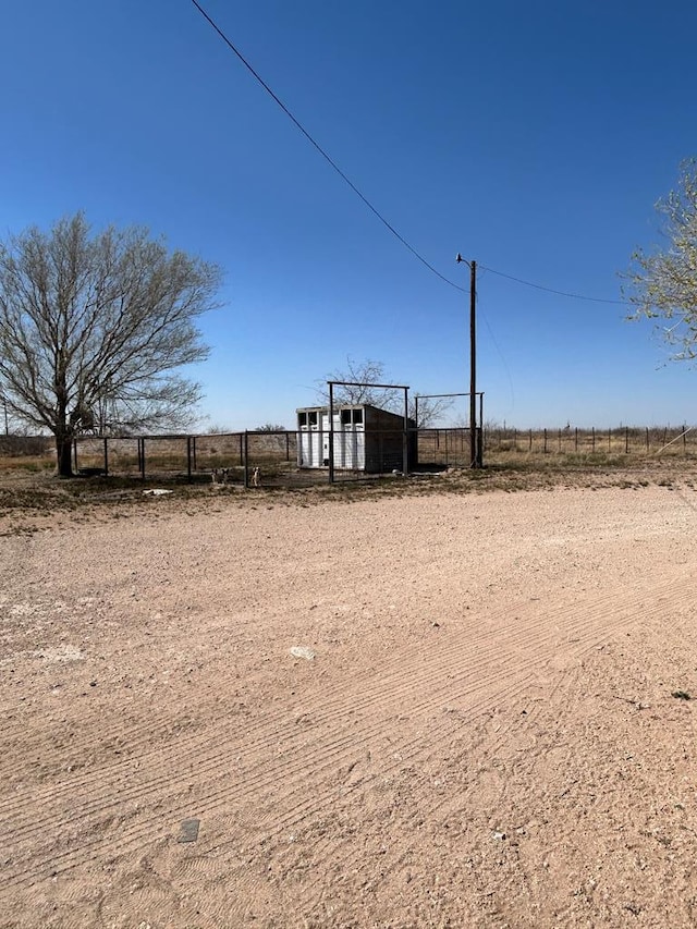 view of yard featuring a rural view and fence