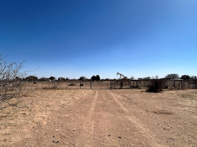 view of yard with a rural view and fence