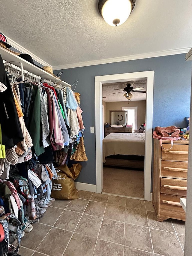 walk in closet featuring ceiling fan