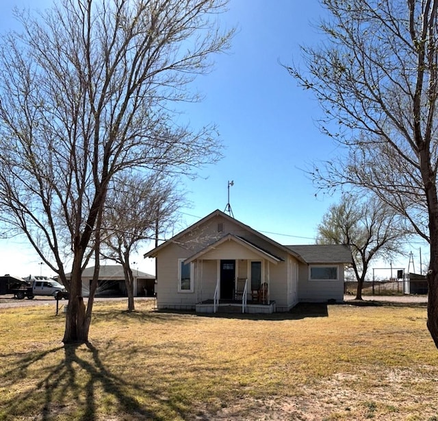 back of property featuring a lawn