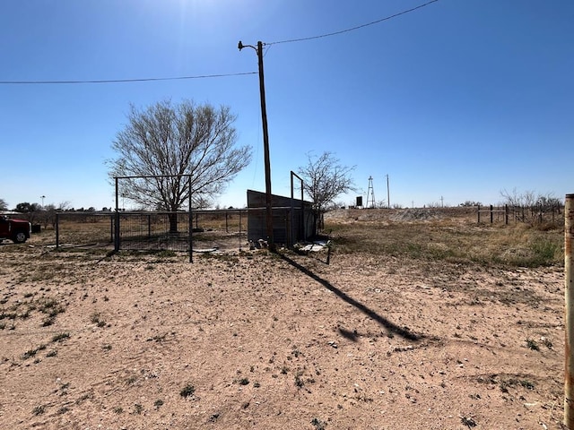 view of yard featuring a rural view and fence