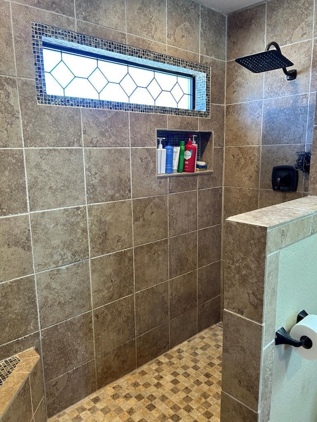 bathroom with tiled shower