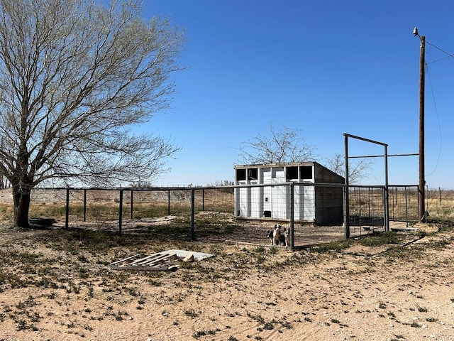 view of yard with an outdoor structure, exterior structure, and fence