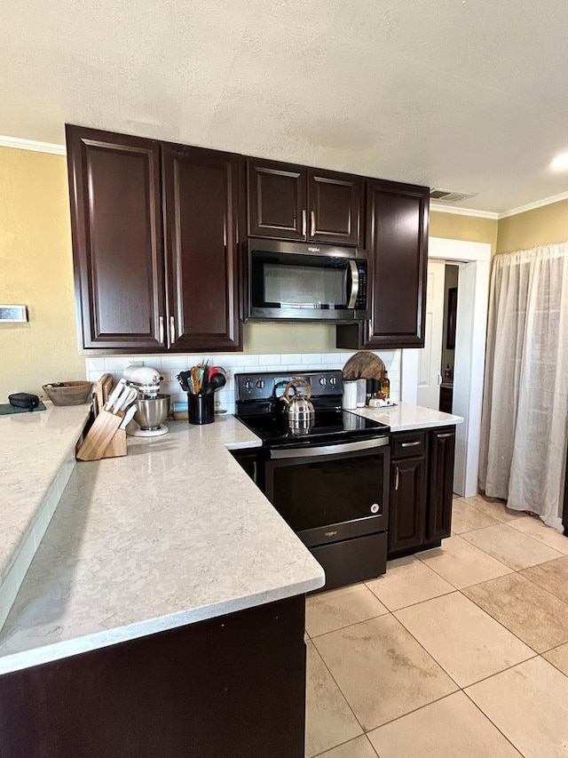 kitchen with stainless steel microwave, ornamental molding, light countertops, and black electric range