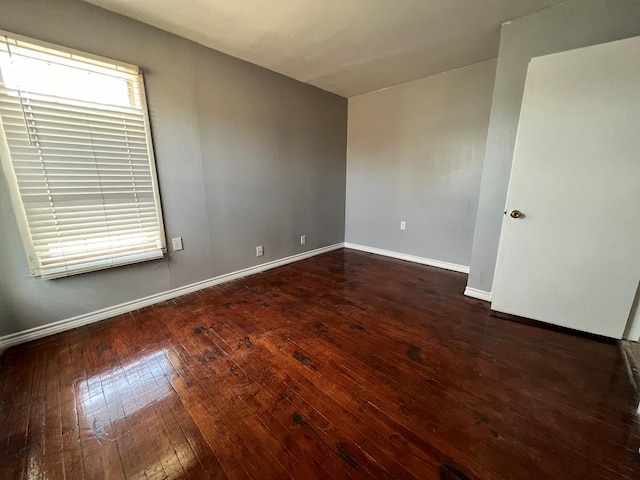 614 W Nobles Ave, Midland, TX 79701 - spare room featuring wood-type flooring and baseboards