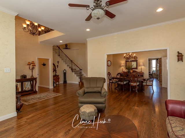 living area with stairs, wood finished floors, and ornamental molding