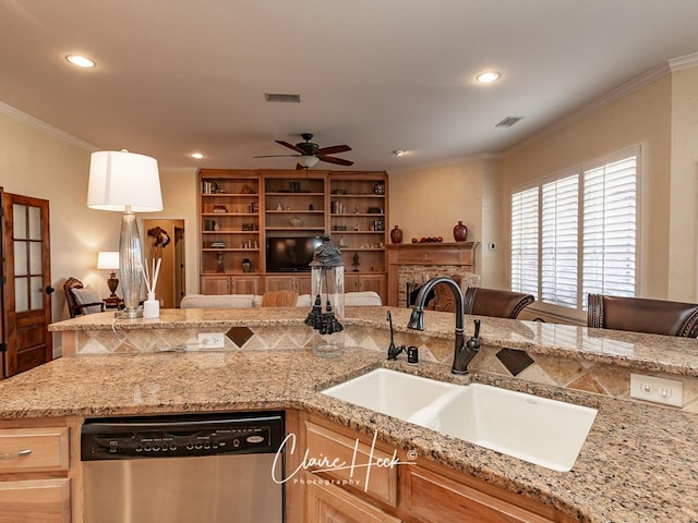 kitchen featuring open floor plan, ornamental molding, dishwasher, and a sink