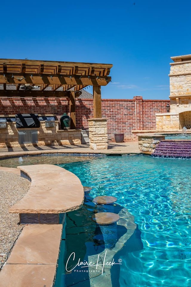 view of pool featuring pool water feature, a jacuzzi, a pergola, and a patio