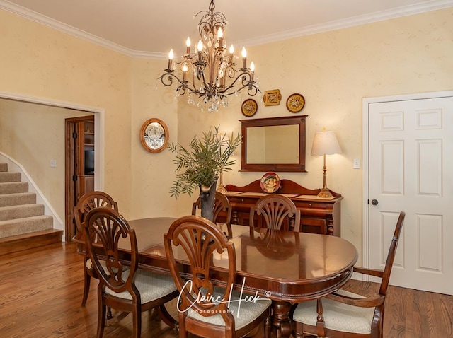 dining room featuring stairway, baseboards, wood finished floors, and crown molding