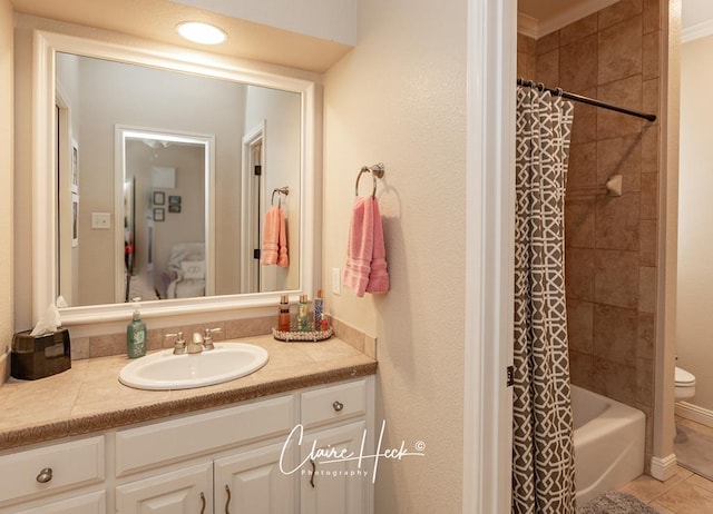 full bathroom with tile patterned flooring, shower / bath combo with shower curtain, toilet, and vanity