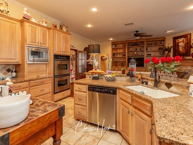 kitchen with light brown cabinets, sink, ceiling fan, ornamental molding, and appliances with stainless steel finishes