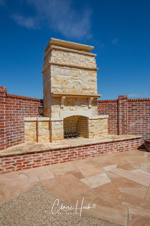 view of patio featuring an outdoor fireplace