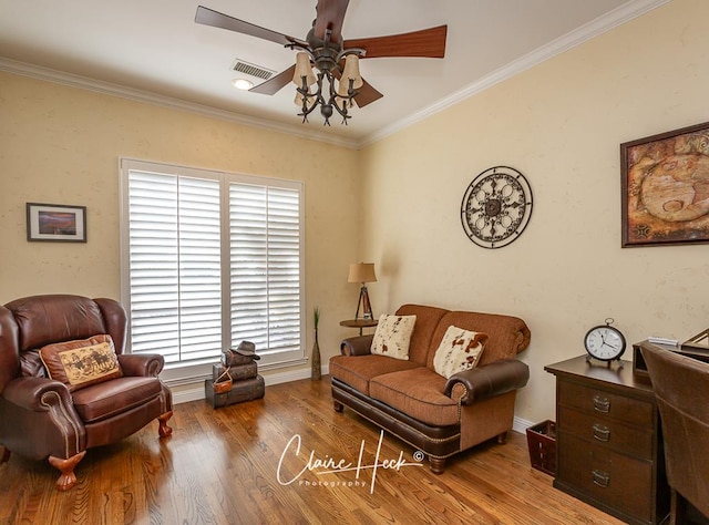 sitting room with ornamental molding, baseboards, a ceiling fan, and wood finished floors