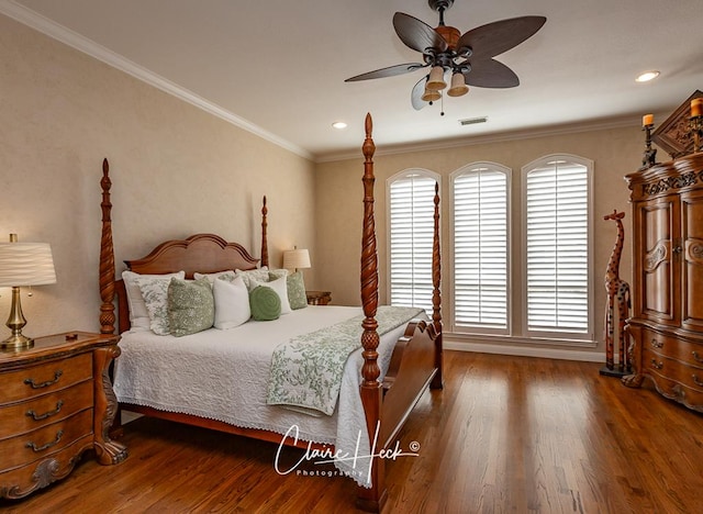 bedroom with visible vents, crown molding, ceiling fan, and wood finished floors