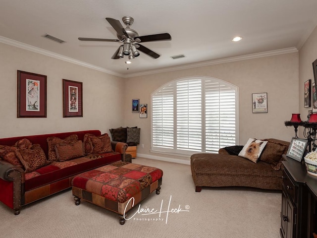 living area featuring a ceiling fan, crown molding, carpet, and visible vents