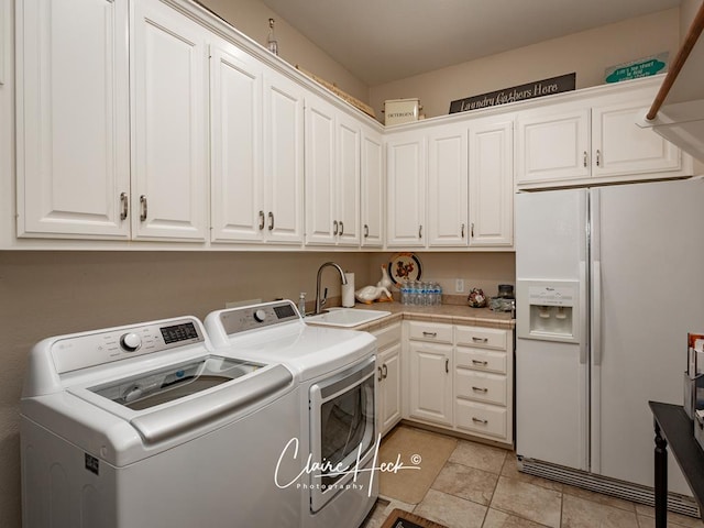 clothes washing area with washing machine and clothes dryer, light tile patterned floors, cabinets, and sink