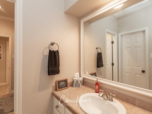 bathroom with vanity and ornamental molding