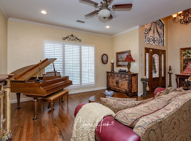 interior space featuring crown molding, hardwood / wood-style floors, and ceiling fan with notable chandelier