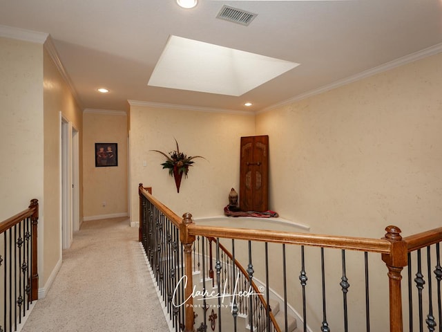 hallway featuring ornamental molding and a skylight