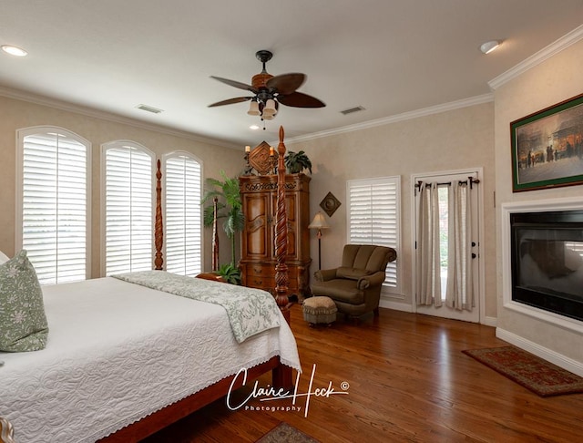 bedroom featuring hardwood / wood-style flooring, ceiling fan, and ornamental molding