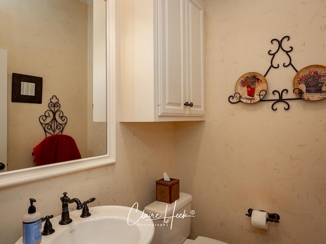 bathroom with toilet and sink