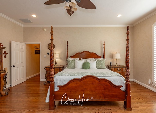 bedroom with ceiling fan, crown molding, baseboards, and wood finished floors