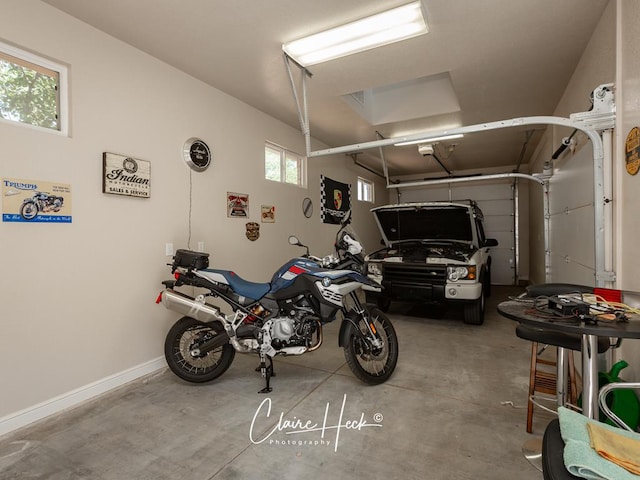 garage with a garage door opener and baseboards