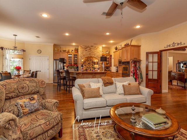 living room with ceiling fan, dark hardwood / wood-style flooring, and crown molding