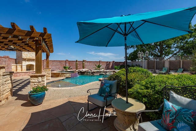 view of patio / terrace with a pool with connected hot tub, a pergola, and fence