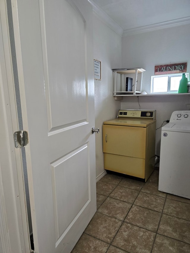 clothes washing area featuring crown molding, laundry area, and washer and clothes dryer
