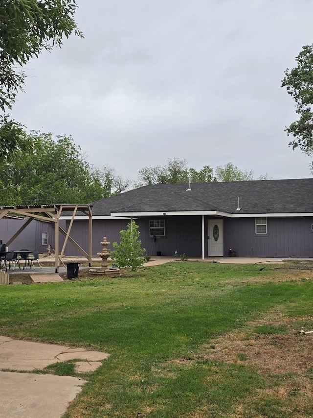 back of property featuring a lawn and a patio area