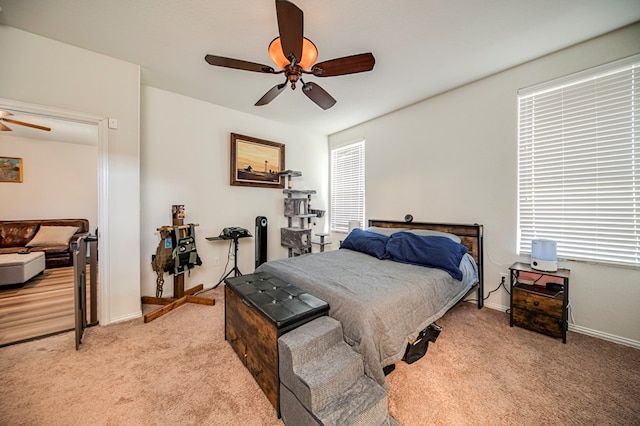 bedroom with ceiling fan and light colored carpet