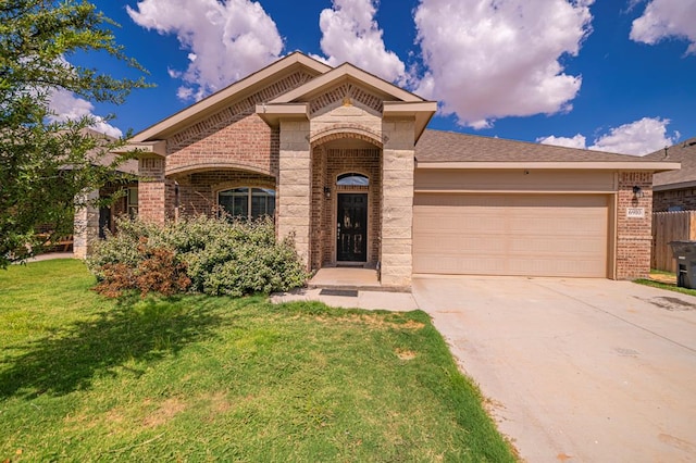 view of front of house with a garage and a front lawn