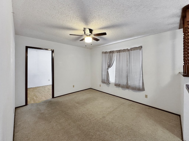 carpeted empty room with a textured ceiling and ceiling fan