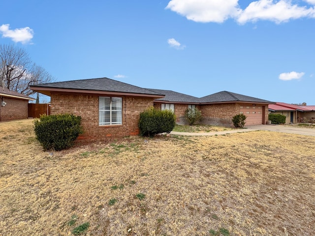 single story home with a garage and a front lawn