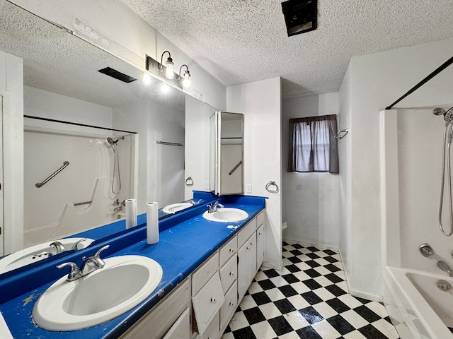 full bathroom with vanity, toilet, shower / bath combination, and a textured ceiling