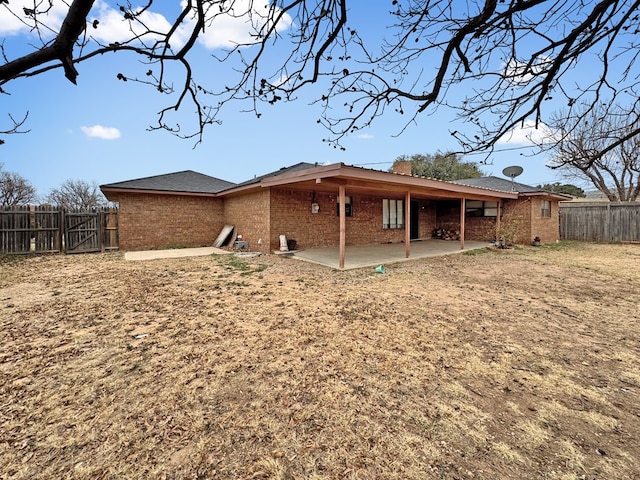 rear view of property with a yard and a patio area