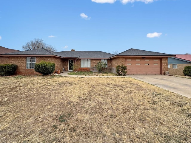 single story home featuring a garage and a front lawn