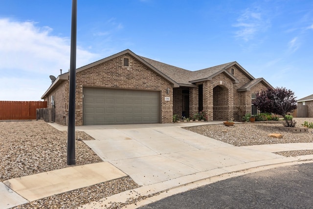 1306 Randolph Ln, Midland, TX 79705 - view of front facade featuring brick siding, an attached garage, concrete driveway, and a shingled roof